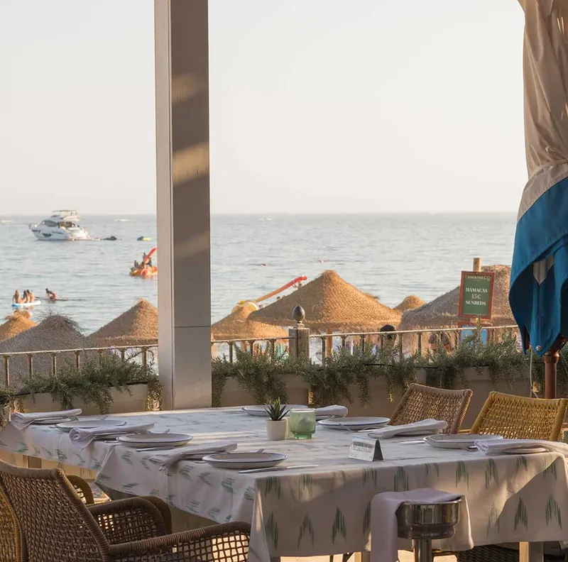 Tamanaco dining terrace with the beach and sea beyond